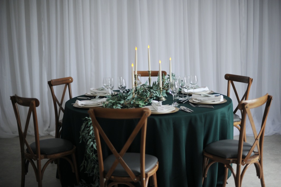 trailing foliage and brass candlestick set table centre